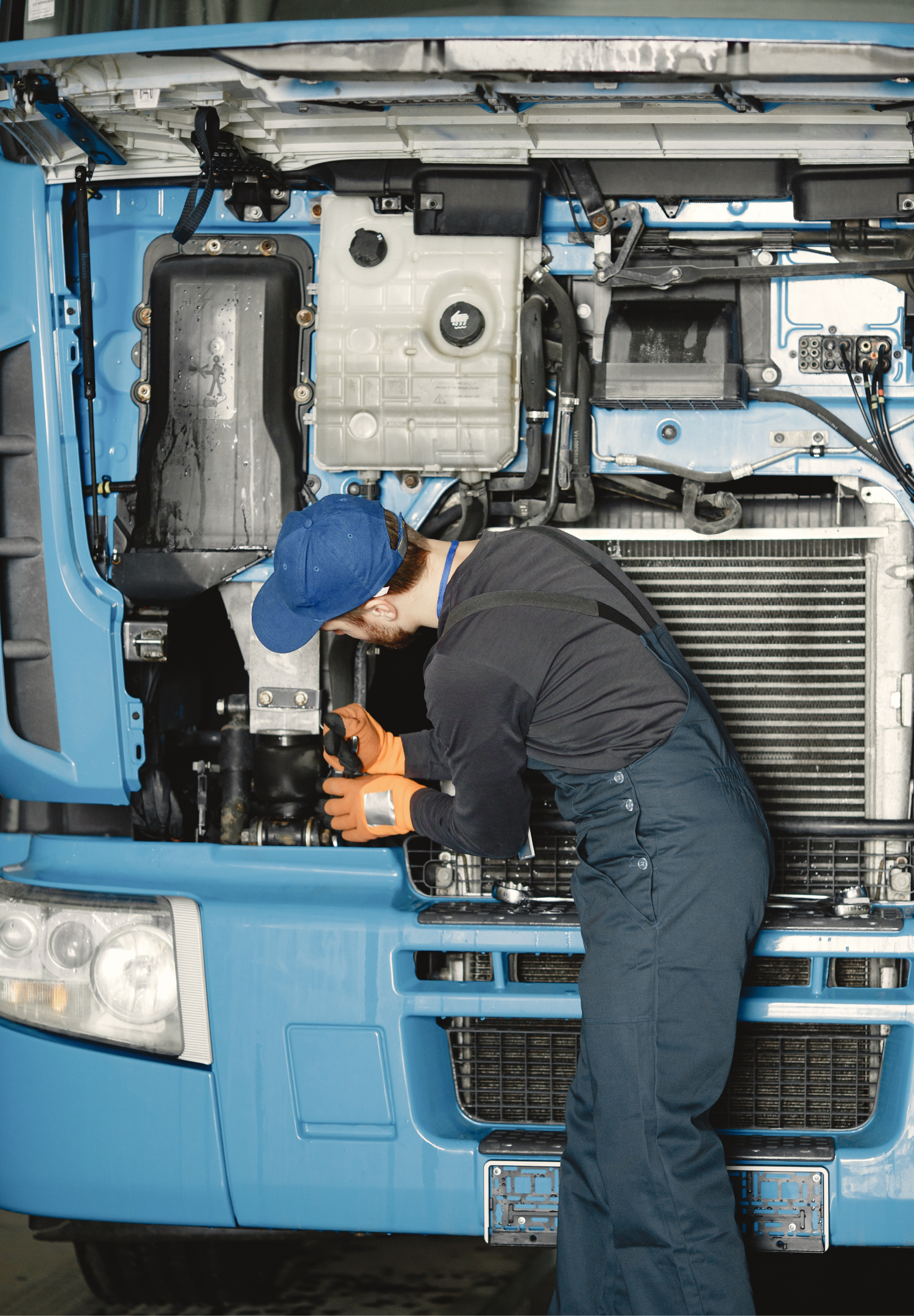 Technician fixing a faulty truck on-site. Technician fixing a faulty truck on-site.